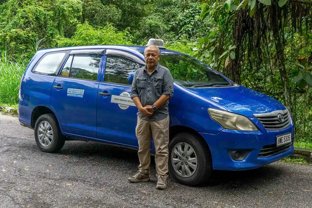 Anuar, licensed taxi driver and operator of My Little Taxi, beside his taxi