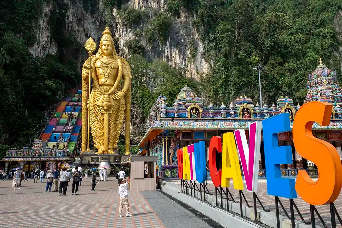 Lord Murugan statue and colourful staircase at the entrance to Batu Caves near Kuala Lumpur