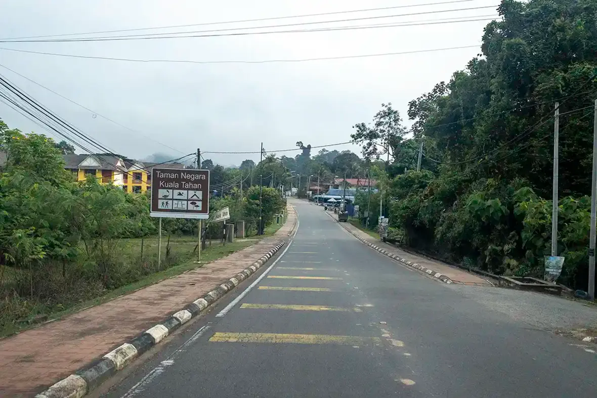 Road entering Taman Negara Kuala Tahan during a private multi-day journey in Peninsular Malaysia