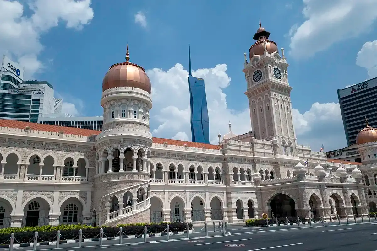 Sultan Abdul Samad Building's copper domes and clock tower at Merdeka Square, with Merdeka 118 rising behind it.