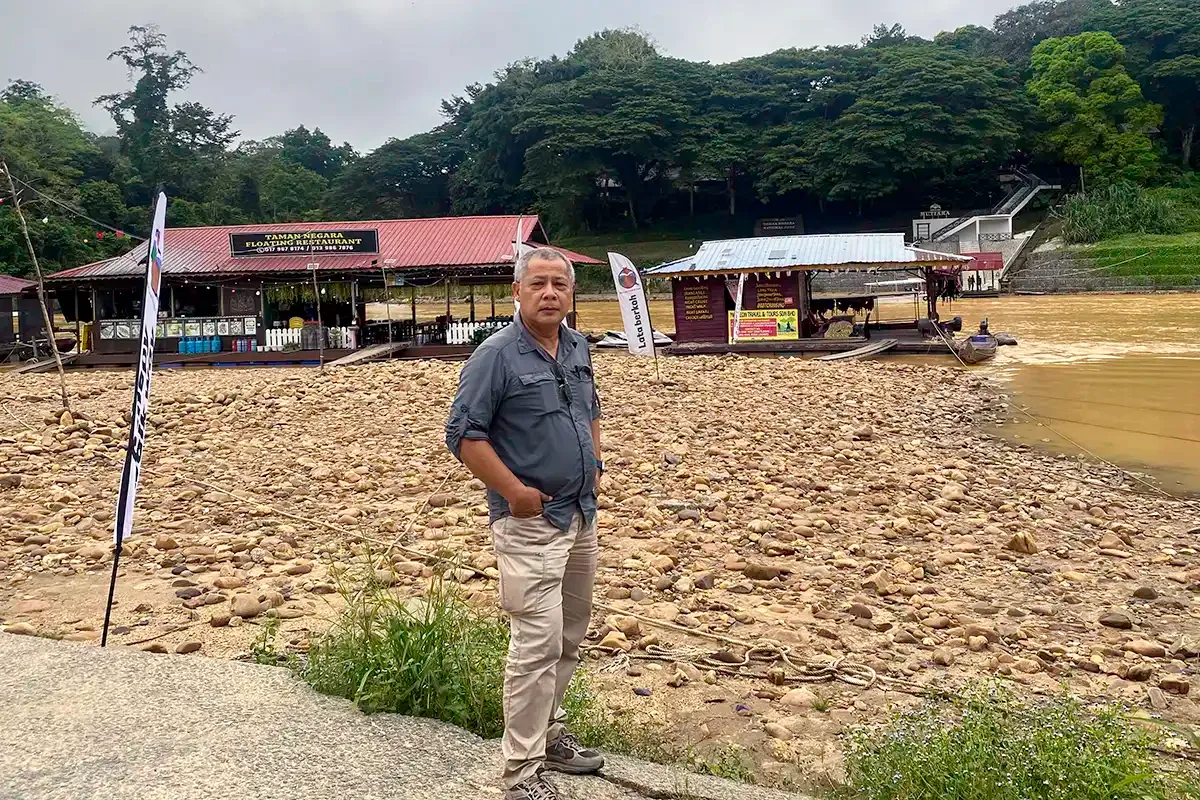 Licensed taxi driver waiting for passengers at a riverside jetty in Taman Negara, Pahang