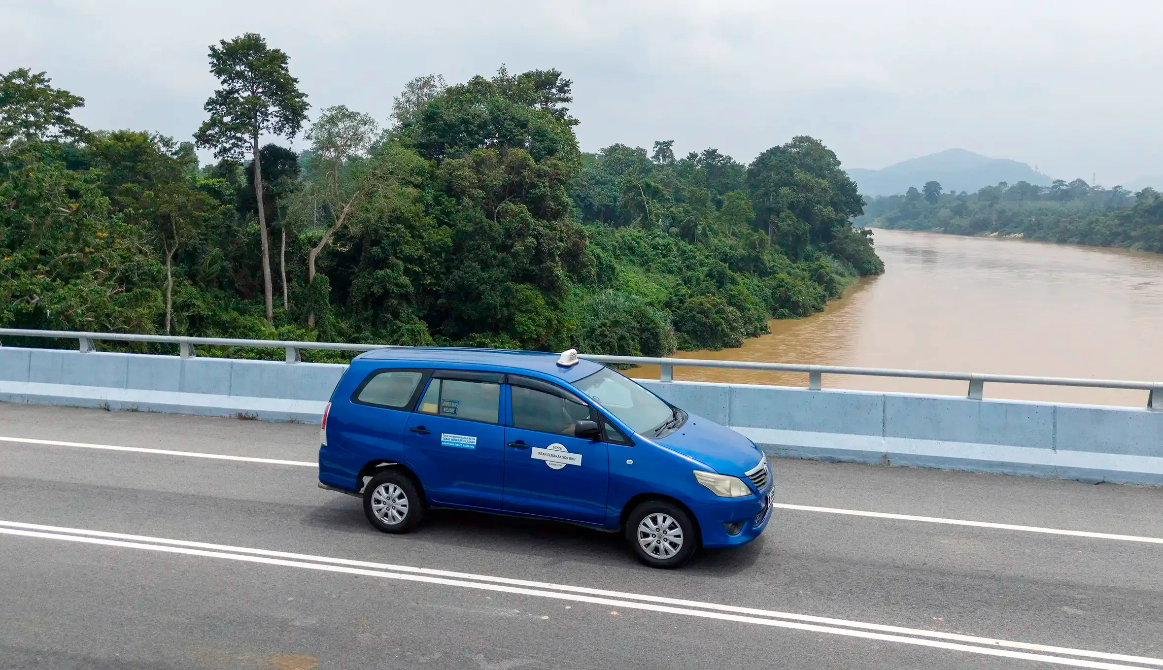 My Little Taxi crossing the Tembeling River bridge on the road to Kuala Tahan, Taman Negara