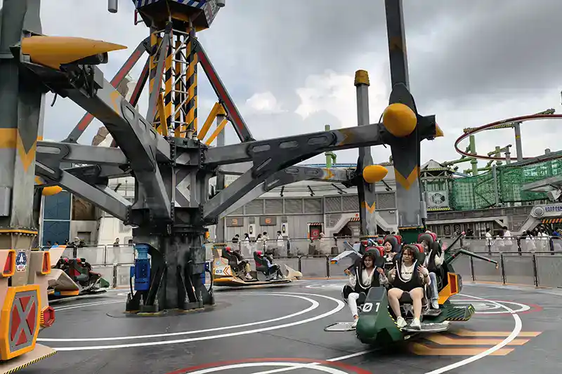 Visitors enjoying a ride at the outdoor theme park in Genting Highlands during a day trip.