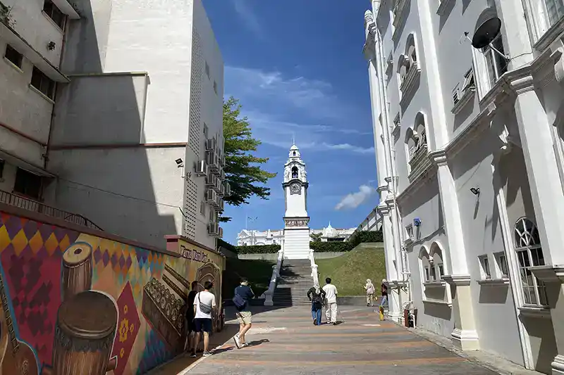 Visitors walking toward the Birch Memorial Clock Tower in Ipoh during a day trip from Kuala Lumpur.