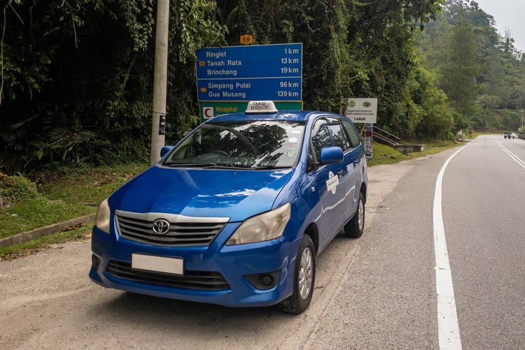 KL to Cameron Highlands private transfer vehicle near Tanah Rata and Brinchang road sign