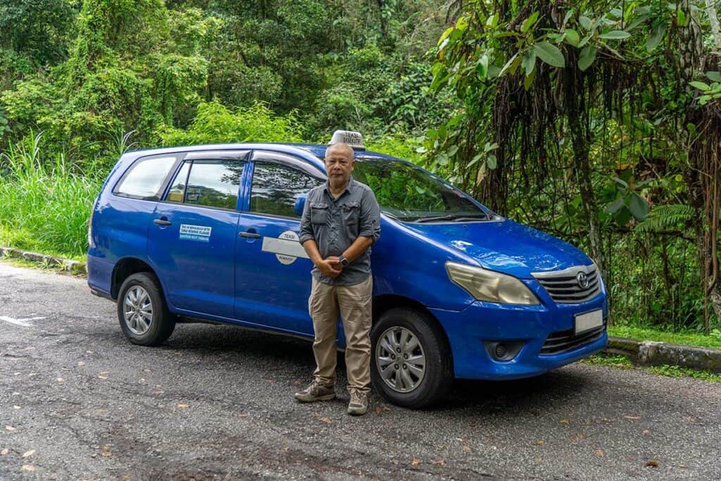 Anuar Ismail beside the Toyota Innova used for private transfers from Kuala Lumpur